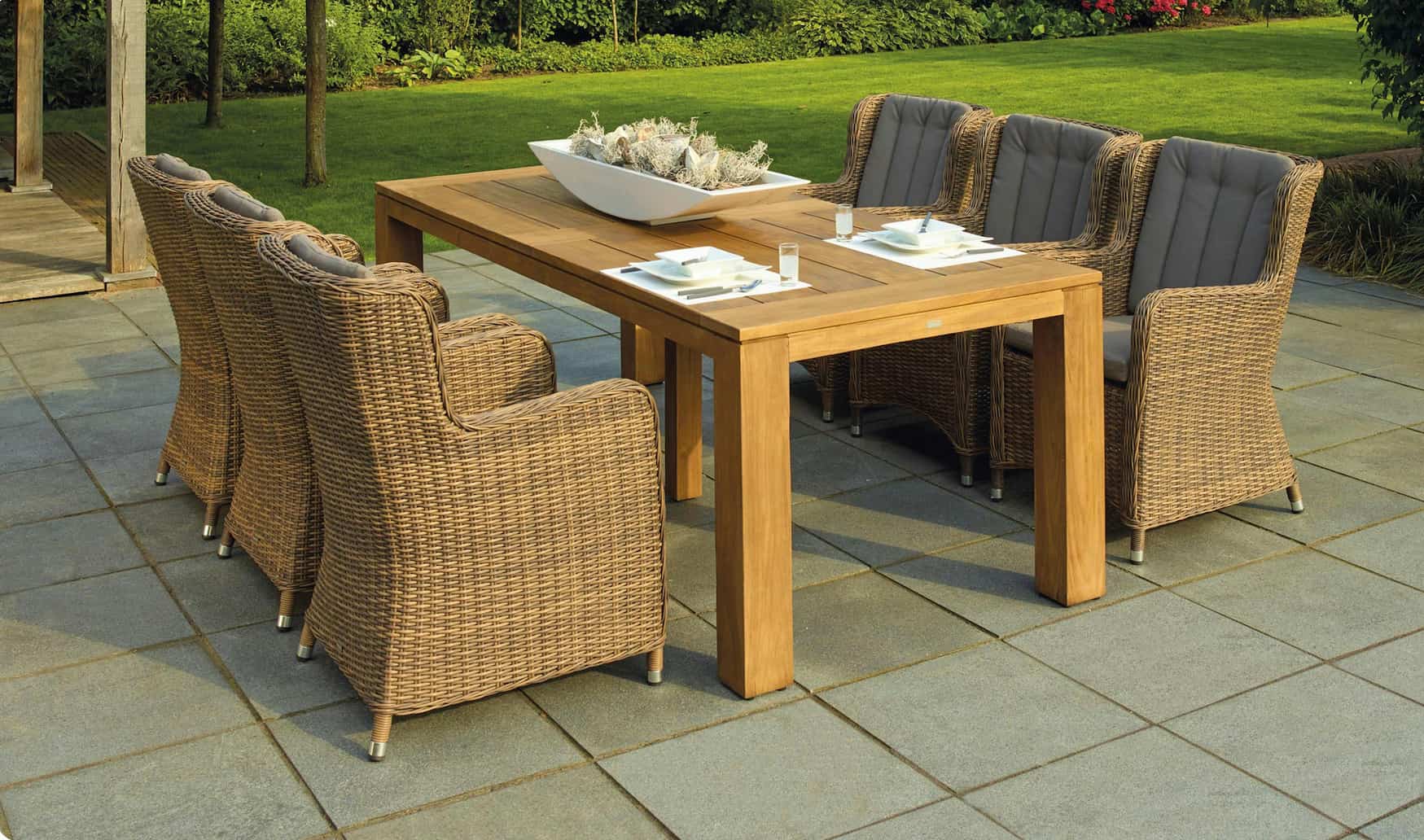 furniture on top of a square patio with grass in the background