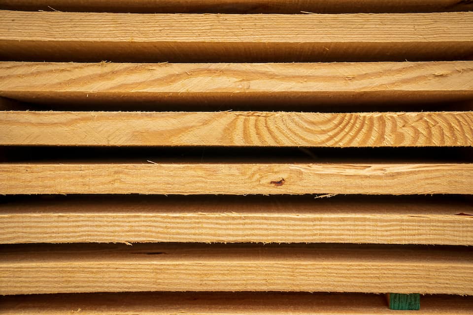 rough sawn timber stacked on top of each other