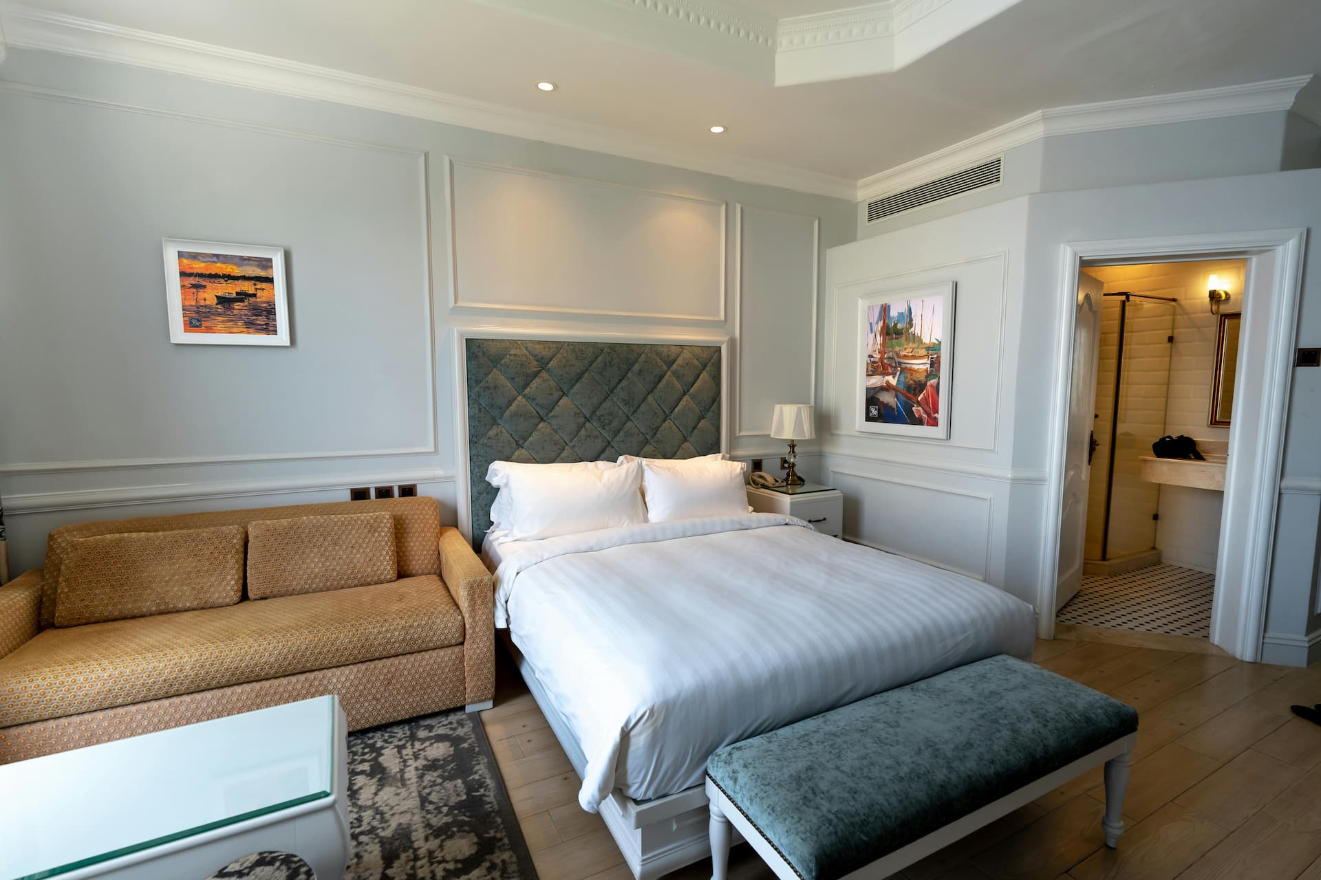 a modern bedroom with double bed and grey walls with wall panelling